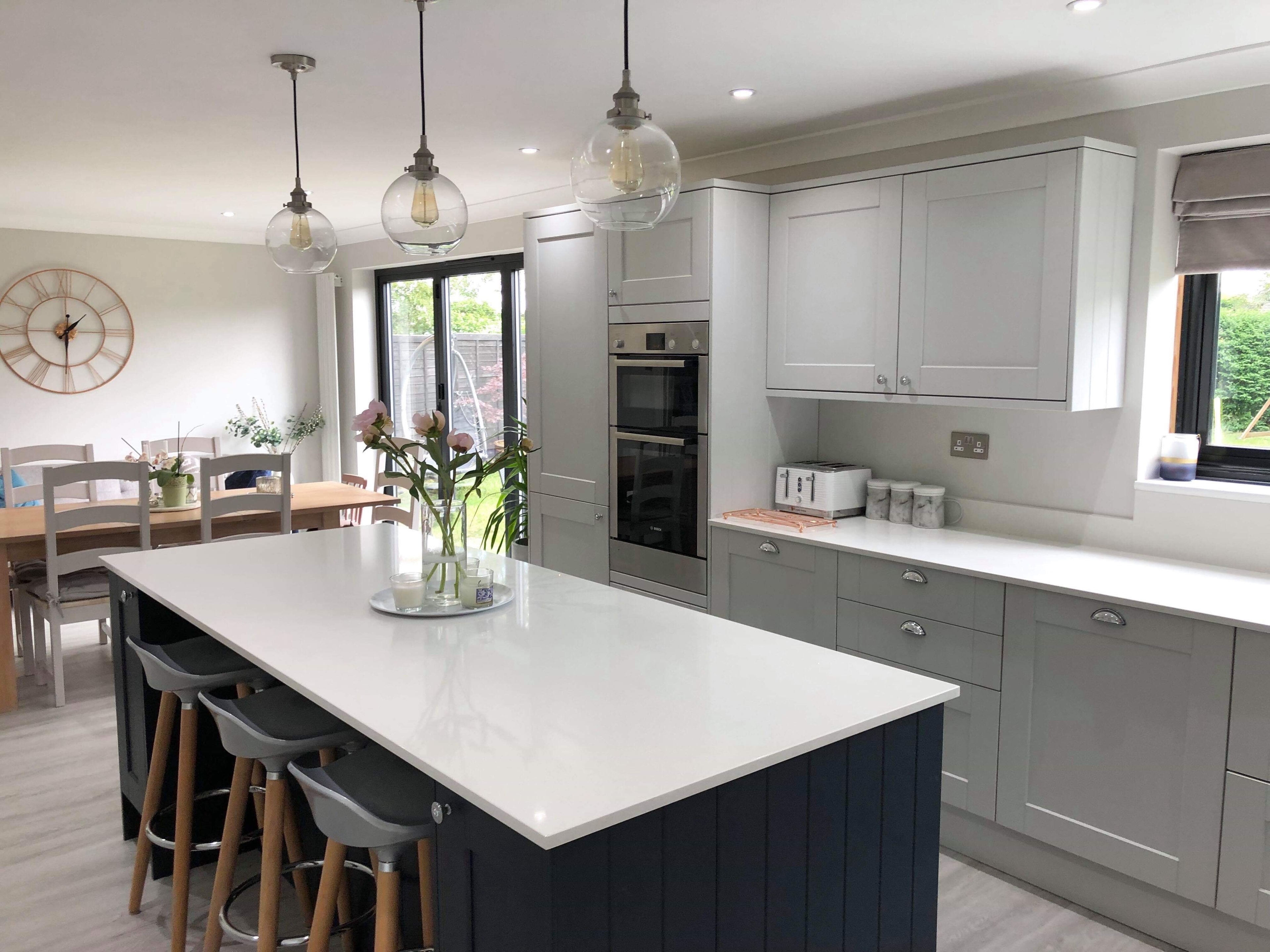 Bespoke light grey shaker kitchen with navy island in Huntingdon Cambridgeshire by Cromwell Interiors