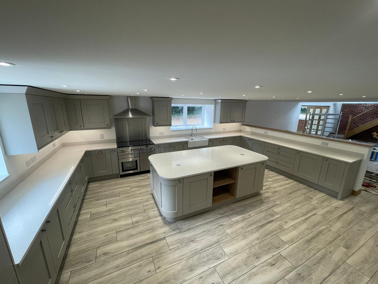 Bespoke kitchen with orange splashback and granite sink in Cambridgeshire by Cromwell Interiors